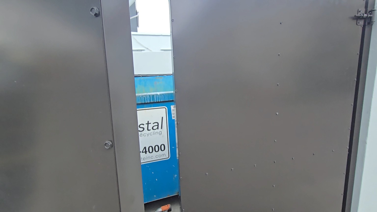 Solid metal panel and fastening detail on the completed enclosure